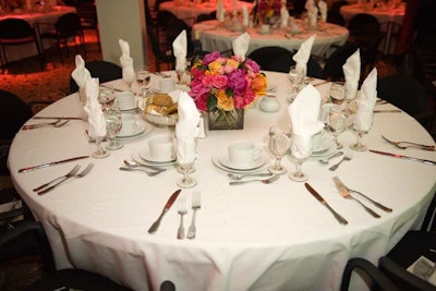 Someone's in the Kitchen catered dinner atop white-clothed tables decorated with flowers from Tick-Tock.