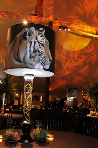 The Flower Firm's decor included oversize lampshades emblazoned with a photo of an Amur tiger. Sound Investment's lighting created a leafy, jungle-like canopy on the ceiling of the tent.
