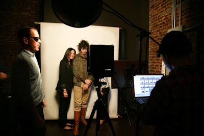 Guests had their pictures taken against a plain white backdrop at a photo station set up by StudioBooth.