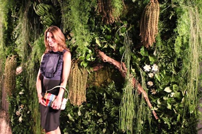 The backdrop for the green-colored red-carpet arrivals area was a vertical living garden, which the organizers have created at previous iterations of the auction. This year, for the first time, the press wall incorporated found branches alongside palm fronds, moss elephant ears, phalaenopsis, air ferns, clovers, cabbage, Boston ferns, pitcher plants, staghorn ferns, asparagus ferns, busy ivy, English ivy, and lemon leaf. Many of the plants were replanted after the event.