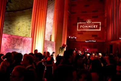 Cocktail hour was in the Gotham Hall balcony, lit in pink and red with rose arrangements to match. Lighting by Bentley Meeker had its peaks and valleys, truth be told. One valley that needed crossing was the directional lighting that lit the Pommery’s toile fabric brand curtains between the columns. The panels looked great, but if you found yourself in a conversation that required you to look the other way, well, the Bruce Springsteen song “Blinded by the Light” comes to mind.