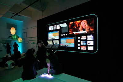The centerpiece of the digital section was a mosaic of computers, TV screens, iPhones, and iPads that was mounted to a wall and highlighted with a speech-bubble-shaped illuminated frame.