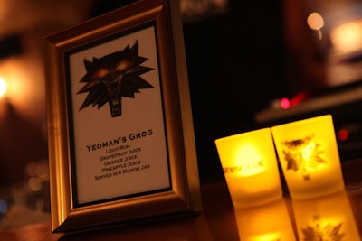 The Wolfcat, a character appearing on a medallion in the game, also appeared on tabletop signage. Thematic specialty drinks included the Yeoman's Grog, made with fruit juices and rum and served in a mason jar.