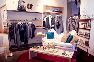 Event Creative designers brought in elements that would make the retail space look like the interior of a hip girl's apartment. The living room vignette had an ornately carved white couch with colorful throw pillows.