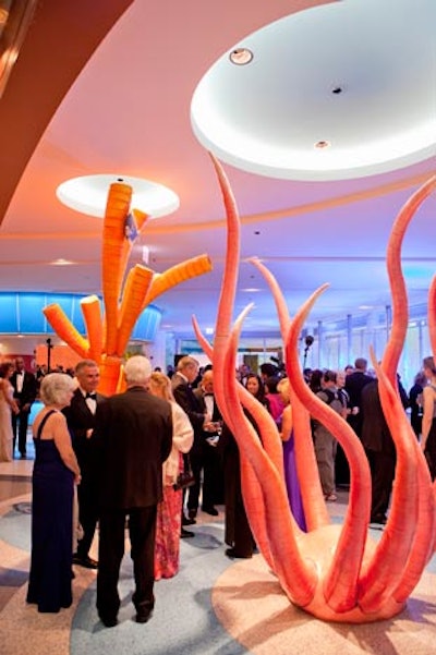 Guests toured the new building. On the second floor, the Anne and Chris Reyes Family Lobby has an aquarium in the wall and oversize sculptures of seaweed.