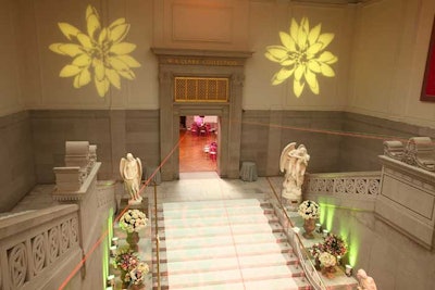 Bright yellow gobos at the top of the staircase helped transition guests from the elegant white of the stairs toward the pinks, yellows, oranges, and neon greens of the bridge area.
