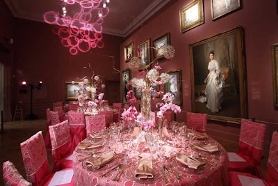 Another French-inspired room had all pink linens, chair covers with white lacy overlays, and gold napkins to match the rose-colored walls.