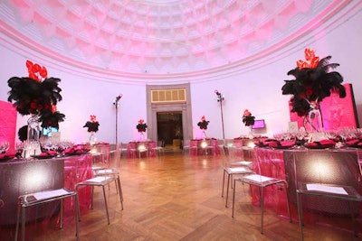 The attendance of the French ambassador inspired the decor in a few galleries, including one with bright pink lighting, plastic table linens, and large black plumes for centerpieces.