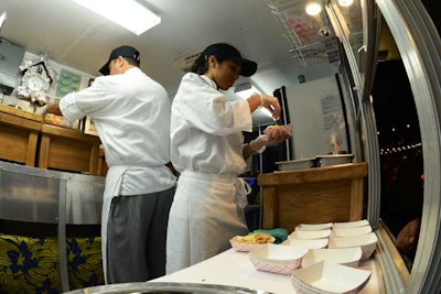 Members of the catering staff use the trucks for final plating of the food, which is all prepared in the hotels' kitchens.