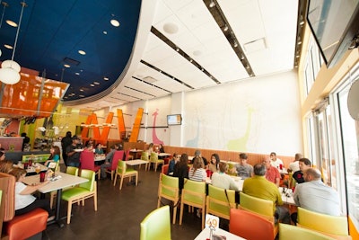 The casual, 80-seat dining room features bright colors and murals of the chain's signature giraffe logo throughout.