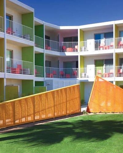 Guest rooms with patios and decks surround the central pool.