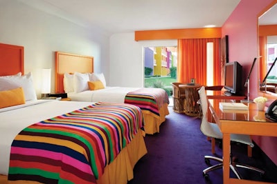 Guest rooms have colorful painted walls, headboards, and bed linens, plus work desks and iPod/iPad connectivity.