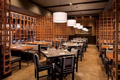 At Tinto, chef Jose Garces focuses on small plates found in traditional tapas bars in northwestern Spain called pintxos. The restaurant's look includes custom-crafted wooden wine racks, black and brown highlighted with lavender upholstered banquettes, wood block tables and chairs, and considerable natural night from glass doors that overlook the patio and pool. Signature dishes include cheese and charcuterie selections typical of the Basque region and an array of traditional tapas.