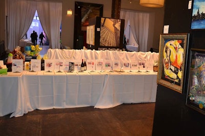 Silent auction tables filled the central room, offering everything from wine to art and theater tickets.