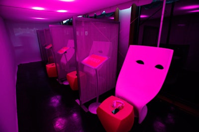 The outdoor terrace was enclosed to create a listening lounge, which consisted of four stations, each equipped with 'Beats by Dr. Dre' headsets and white mask-shaped chairs.