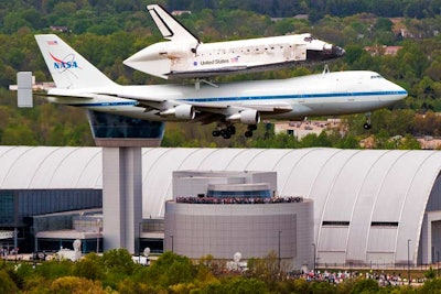 V.I.P. guests watch as the Discovery, mounted atop NASA's Boeing 747 Shuttle Carrier Aircraft, flew by the Smithsonian’s Udvar-Hazy Center Tuesday.