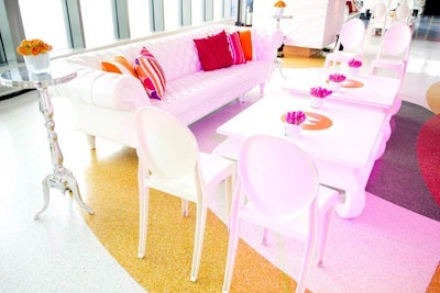 Pillows added pops of magenta and W's signature orange to the all white furniture. The cocktail tables were branded with the W Network logo.