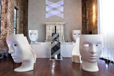 White, mask-shaped chairs, which were used for guest seating as well as decor, served as a focal point in the main room. The brand's logo was also incorporated into the decor, illuminating a wall through laser-projection technology and embedded in some of the furnishings.
