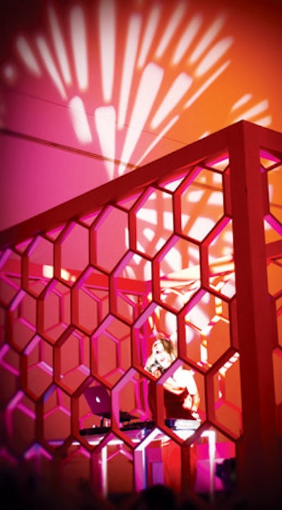 At the Art Ball at the Dallas Museum of Art in April, Todd Events used honeycomb walls, interior Versa tubes, and lighting elements to build a decorative platform for DJ Lucy Wrubel over the registration desk.