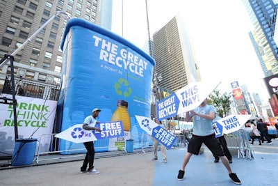 A 30-foot-tall inflatable recycling bin, created by the Alison Group and erected in Times Square. The bin will be reused in other cities and then turned into plastic lumber for GrowNYC's urban garden program. Honest Tea employed sign flippers to attract the attention of passersby.