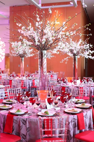 Lavender linens, pink chiavari chairs, and red cushions and plates kept with the colour palate. The decor was inspired by springtime in Paris.