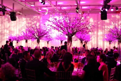 For dinner in Baillie Court, tall cherry blossoms added height to the tables. The space was uplit in pink.