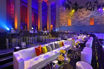 An elevated structure housed a second seating area. Similar to the rest of the venue, the space was furnished with high-top cocktail tables, couches, and ottomans.