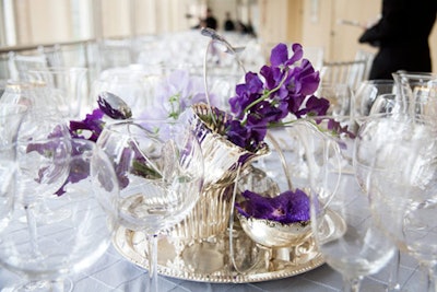 As in past years, around 200 V.I.P. guests (paying $1,500 a head or $15,000 a table) dined upstairs on a mezzanine overlooking the grand promenade. The centerpieces were made of welded-together silverware and silver dishes accented with purple sweet peas and orchids, in honor of the foundation's silver anniversary.