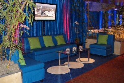 Exotic metallic blue draping with fuchsia uplighting encircle distinctive furniture