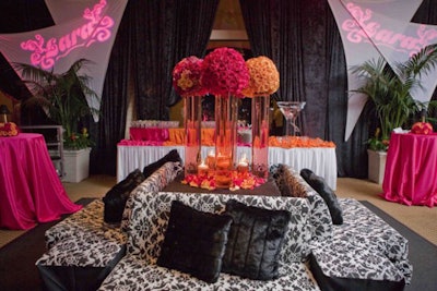 Printed couches surround a pop of color and gobo projections