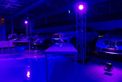 During dinner, the event team removed the draping to reveal exposed truss and hoisted Mercedes vehicles, adding a more industrial look to the space used moments earlier for the reception.