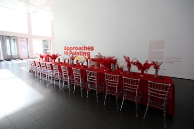 Topped with festive arrangements of ostrich feathers, a communal table provided seating in the atrium.
