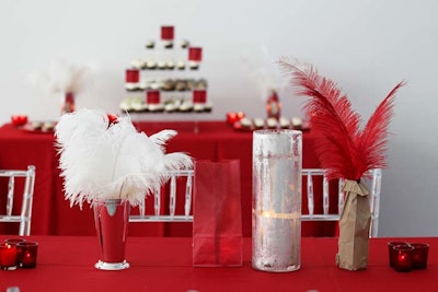 Candles in red glasses and feathers in vintage cups decked tabletops. Red linens played into the supper-club vibe.