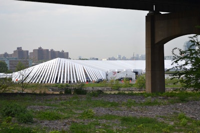 The clear-span tent made of vinyl and aluminum is a bespoke structure modified from standard rental-tent technology. The plywood floor of the 250,000-square-foot venue featured a painted top that can be reused in future years. There were 1,900 house lights on-site and the entire structure was temperature- and humidity-controlled with a full, water-chilled HVAC system running on biodiesel-powered generators.