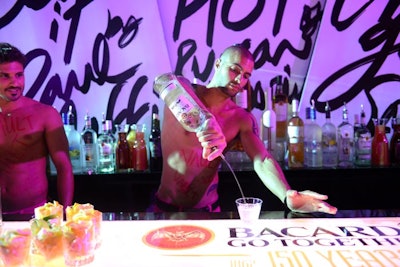 Five topless male models served drinks at the main gratis top-shelf bar.