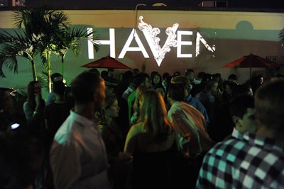 At an exclusive outside patio, a red carpet covered the asphalt and the Haven logo was projected in colored lighting on the wall.