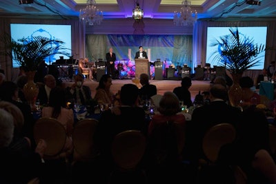 A Moroccan garden inspired the ballroom's setting, which had deep blue lighting and palm leaves spilling out of patterned vases.