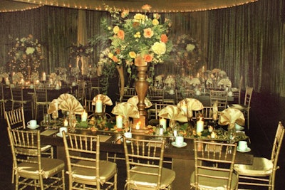 Thick gold wooden candelabras filled with peach and yellow roses