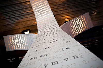 Columns with carved-out words from the script were meant to look like pages fanning out over guests.