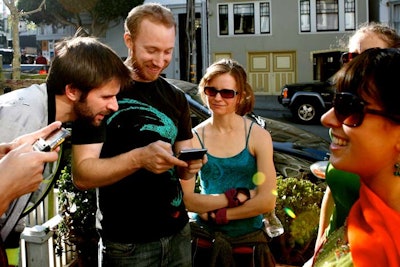 During tech-driven Go Game scavenger hunts, participants use smartphones to download clues and missions for their teams.