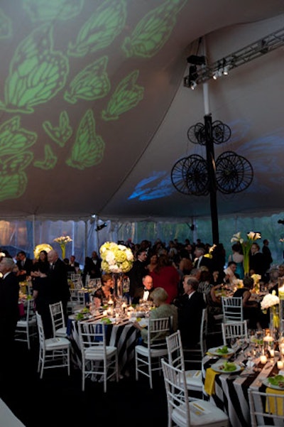 Images of fluttering butterflies illuminated the ceiling of the dinner tent.
