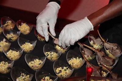 Guests ate grilled lamb chop cups with cous cous and tzatziki.