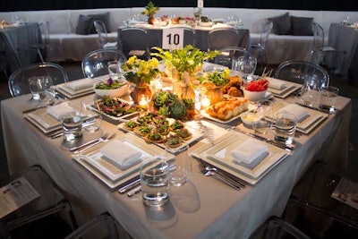 The first course of the meal was preset prior to the guests' arrival and included dinner rolls, seared venison bites, and spring asparagus tarts. The centerpieces consisted of small burlap sacks filled with air ferns, tree peonies, and dahlias, which the guests could take home with them.