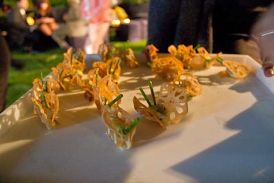 During the cocktail reception, waitstaff passed canapes by Bite Food, including sweet pea dumplings, crispy baby turnips, and a butterfly-shaped dish of bacalao, lotus root crisps, green garlic mash, and chives (pictured).