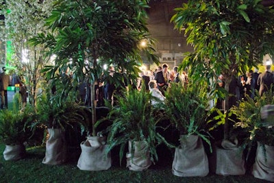 Live trees individually bagged in burlap sacks served as the partition to enclose the cocktail area, while adding to the decor.