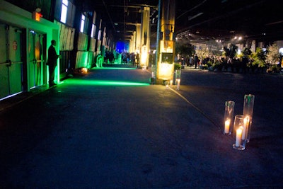 Inside the raw concrete space of Pier 57, the organizers placed candles to light the way to the dining and cocktail areas. Arranged in small clusters of three or four, the candles were placed in tall glass vases.