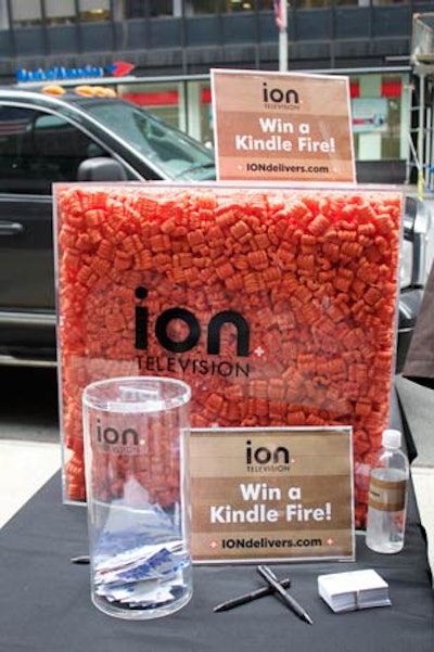 To encourage invited participants to linger, Ion's mobile mail room also offers a daily competition. Execs can drop off their business cards and estimate the amount of packing peanuts inside a glass cube for a chance to win a Kindle Fire. The network also set up a promotional Web site, which awards $1,000 those that answer Ion TV quizzes or share the link with friends.