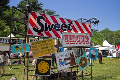 Organizers scattered circus-style signs depicting food-related phrases and pictures throughout the park to create an amusement-park-like setting.