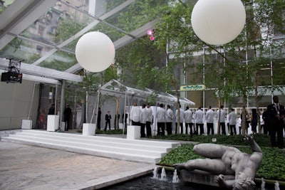 In the garden, the design was kept simple. Astroturf was installed to cover some areas of the space and to match the decor inside the museum. For a cool visual effect during the after-party, organizers hung white globes from the tent to reflect lighting, provided by Bentley Meeker.