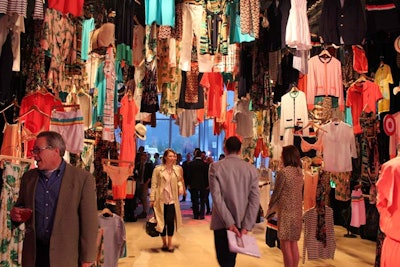 Designed as a series of vignettes, the event offered a collage of products from the collection. The first section was a tunnel of clothing, reminiscent of displays found at bazaars, which saw apparel from Miami-based luxury boutique the Webster attached to an anchoring truss structure masked in black fabric.